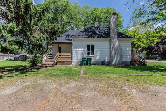 324 W Sumner St, Streator, IL 61364 - rear view of property with covered porch, a chimney, and a lawn