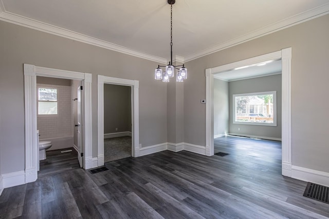 324 W Sumner St, Streator, IL 61364 - unfurnished dining area featuring healthy amount of natural light, dark wood-style flooring, crown molding, and baseboards