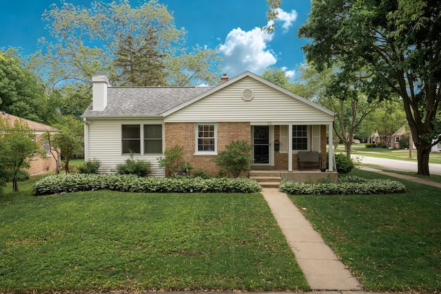 55 S Elmwood Ave, Palatine, IL 60074 - ranch-style home with covered porch, a front lawn, a chimney, and brick siding