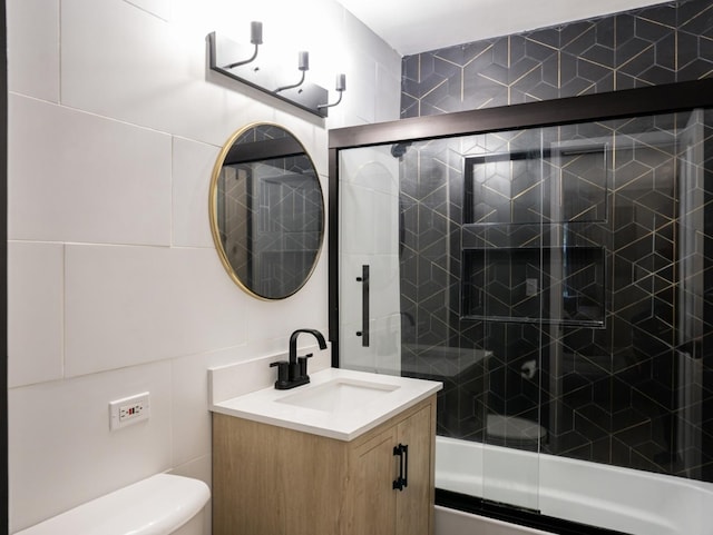 55 S Elmwood Ave, Palatine, IL 60074 - bathroom featuring vanity, bath / shower combo with glass door, toilet, and tile walls