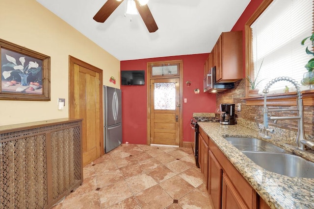 3942 W 64th St, Chicago, IL 60629 - kitchen with appliances with stainless steel finishes, a sink, decorative backsplash, and brown cabinets