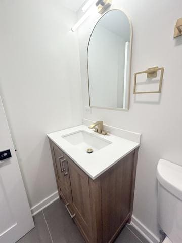 9536 S Woodlawn Ave, Chicago, IL 60628 - half bath with vanity, toilet, baseboards, and tile patterned floors