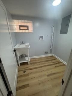 9536 S Woodlawn Ave, Chicago, IL 60628 - laundry room with electric panel, baseboards, and wood finished floors