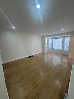 9536 S Woodlawn Ave, Chicago, IL 60628 - unfurnished room featuring wood finished floors and baseboards