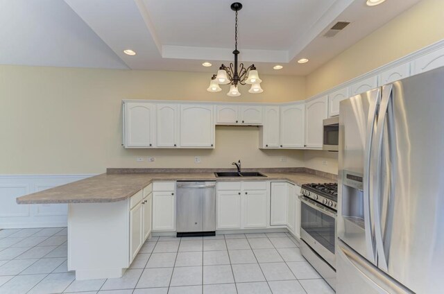 262 Jennifer Ln Unit 262, Wilmington, IL 60481 - kitchen featuring appliances with stainless steel finishes, a sink, a peninsula, recessed lighting, and white cabinets