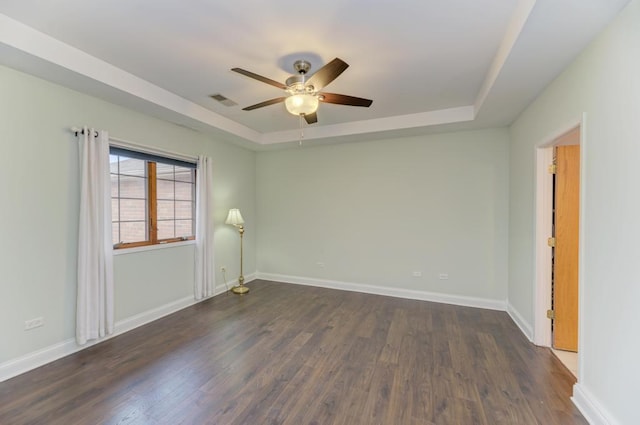 262 Jennifer Ln Unit 262, Wilmington, IL 60481 - unfurnished room with a raised ceiling, a ceiling fan, dark wood-style flooring, and baseboards