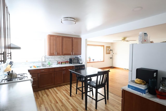 4525 W 125th St, Alsip, IL 60803 - kitchen featuring stainless steel microwave, light countertops, freestanding refrigerator, and light wood-style floors