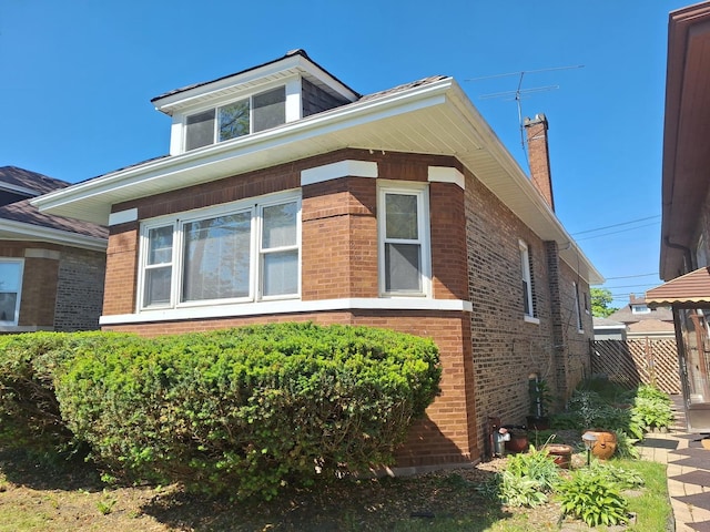 8732 S Laflin St, Chicago, IL 60620 - view of side of home with brick siding and a chimney
