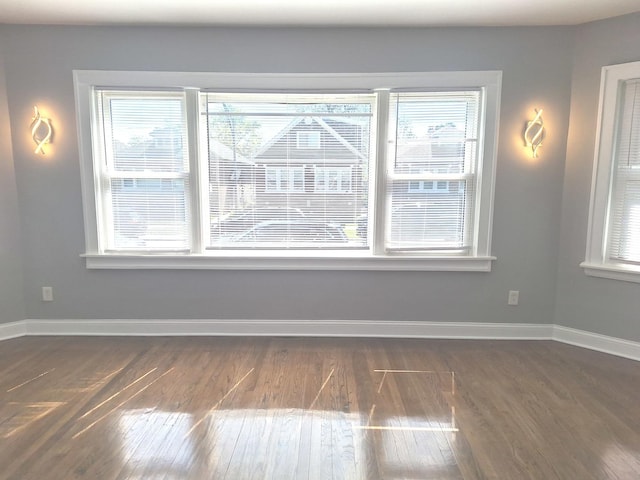 8732 S Laflin St, Chicago, IL 60620 - unfurnished room with plenty of natural light, dark wood finished floors, and baseboards