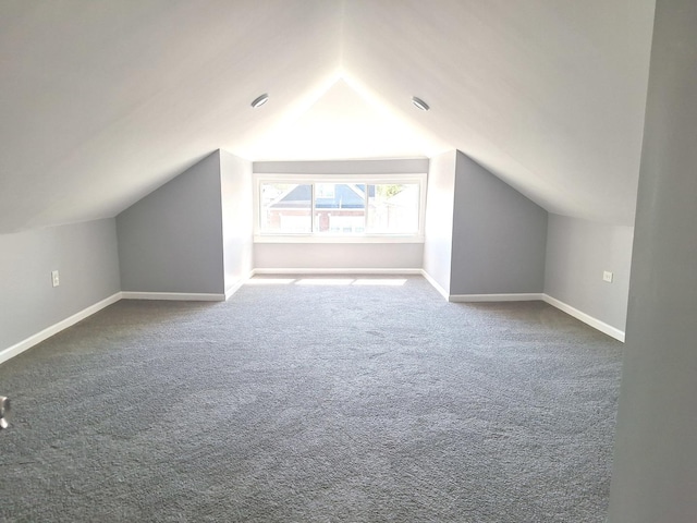 8732 S Laflin St, Chicago, IL 60620 - additional living space with vaulted ceiling, dark carpet, and baseboards