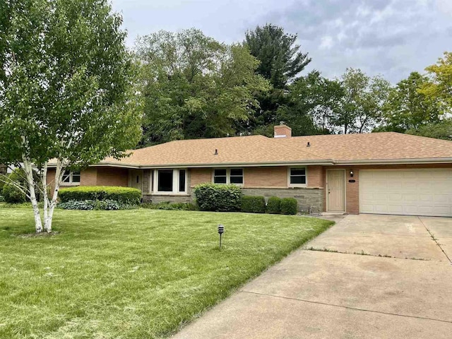 1915 Greenfield Ln, Rockford, IL 61107 - single story home featuring a garage, concrete driveway, a front lawn, and a chimney