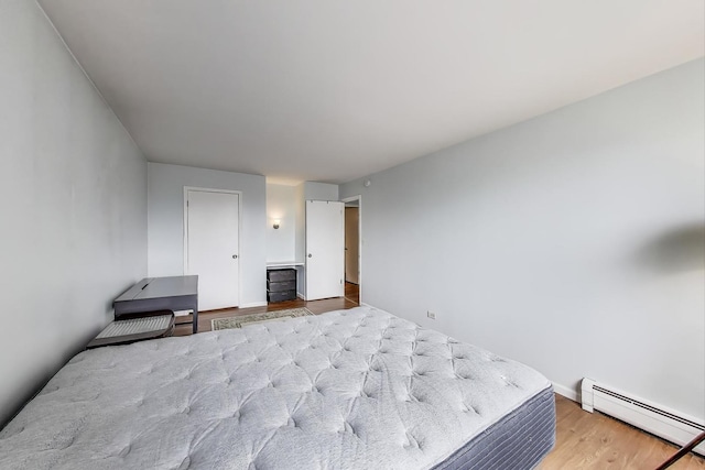 6325 N Sheridan Rd Unit 608, Chicago, IL 60660 - bedroom featuring a baseboard heating unit, wood finished floors, and baseboards