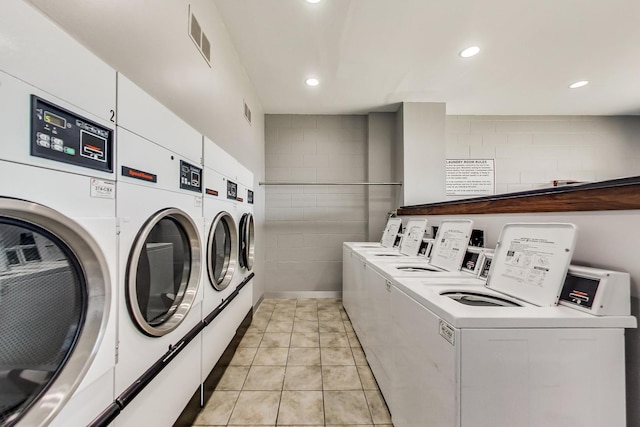 6325 N Sheridan Rd Unit 608, Chicago, IL 60660 - community laundry featuring independent washer and dryer, recessed lighting, concrete block wall, and light tile patterned floors