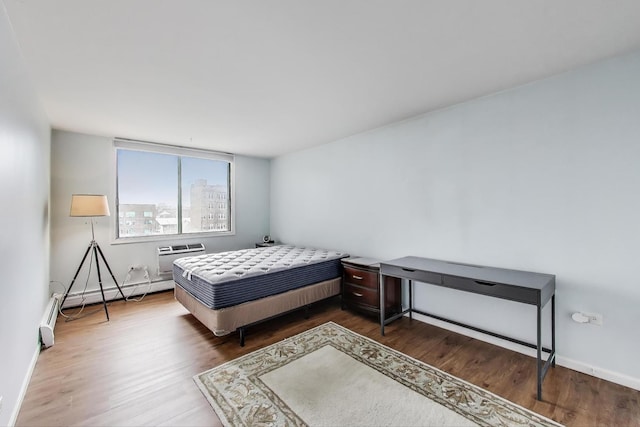 6325 N Sheridan Rd Unit 608, Chicago, IL 60660 - bedroom featuring wood finished floors, baseboards, baseboard heating, and an AC wall unit