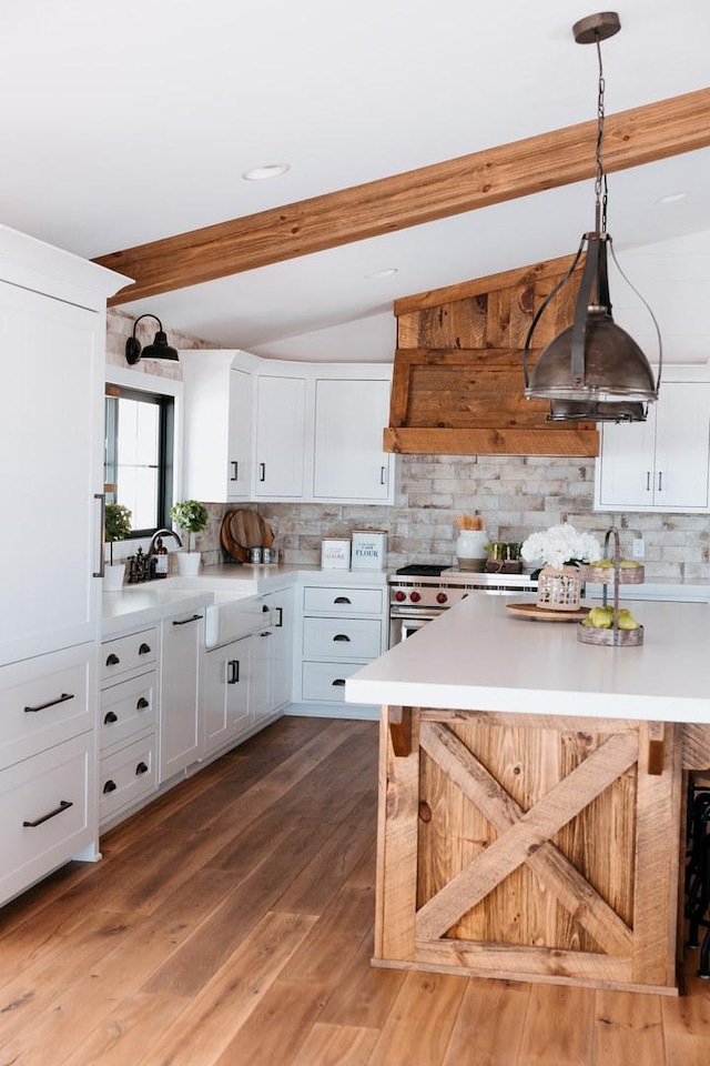 281 Snipe Hollow Rd N, Elizabeth, IL 61028 - kitchen with decorative backsplash, white cabinets, a breakfast bar, light countertops, and a sink
