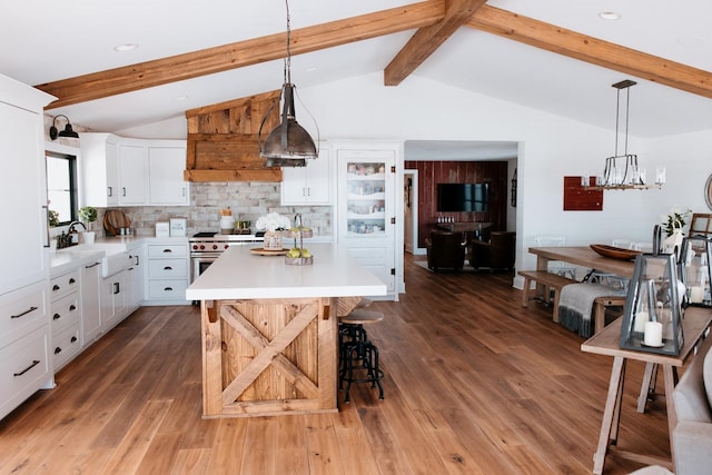 281 Snipe Hollow Rd N, Elizabeth, IL 61028 - kitchen with a sink, light countertops, a breakfast bar area, white cabinets, and wood finished floors