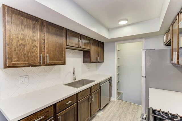 7 Fernwood Dr Unit Q, Bolingbrook, IL 60440 - kitchen with a sink, appliances with stainless steel finishes, light wood-type flooring, backsplash, and light countertops