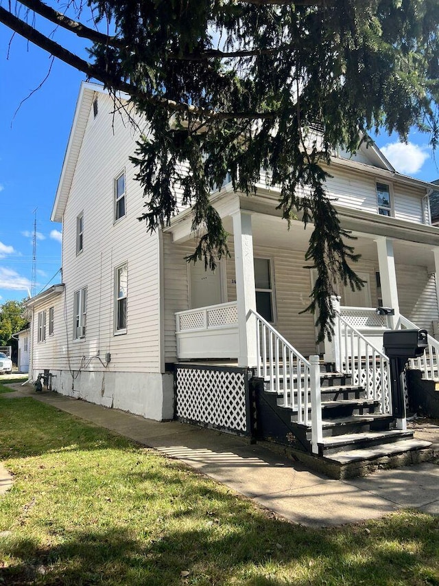 360 S Washington Ave, Kankakee, IL 60901 - view of front of property with covered porch, a front lawn, and stairs