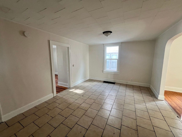 360 S Washington Ave, Kankakee, IL 60901 - empty room featuring arched walkways and light tile patterned flooring