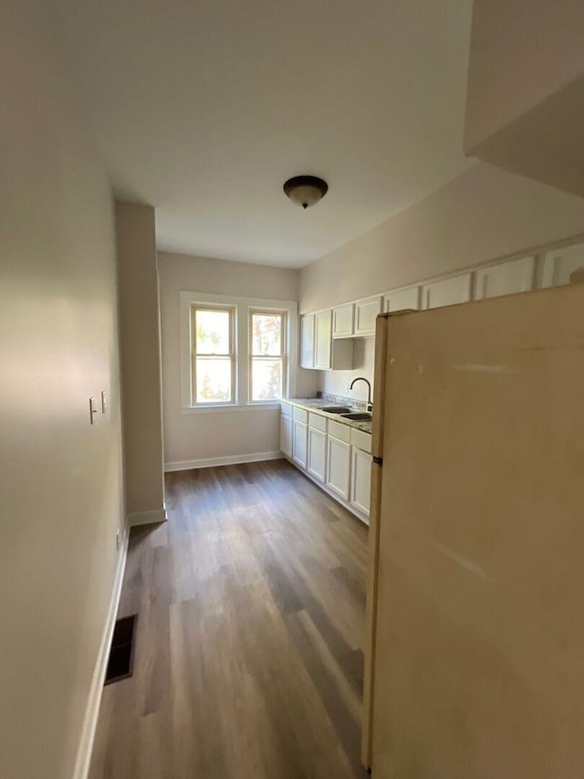 363 E Hickory St, Kankakee, IL 60901 - kitchen with freestanding refrigerator, white cabinetry, and dark wood-type flooring