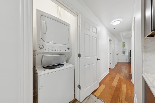 1332 S Keeler Ave, Chicago, IL 60623 - washroom with stacked washer / drying machine, light wood-type flooring, and baseboards