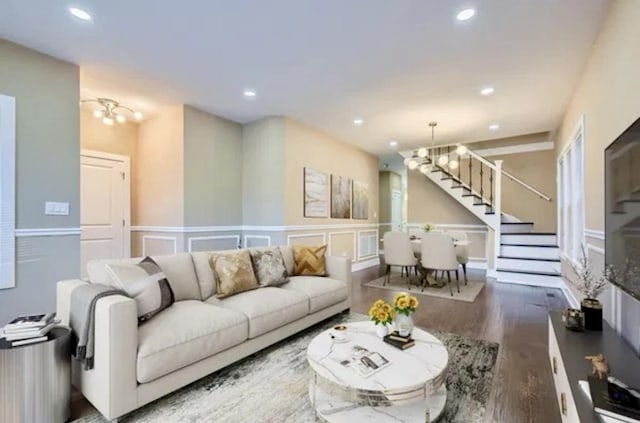 8431 S Crandon Ave, Chicago, IL 60617 - living area featuring stairway, a decorative wall, wood finished floors, recessed lighting, and a wainscoted wall