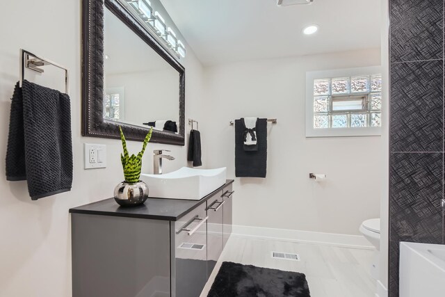 8431 S Crandon Ave, Chicago, IL 60617 - full bathroom featuring vanity, baseboards, toilet, and recessed lighting