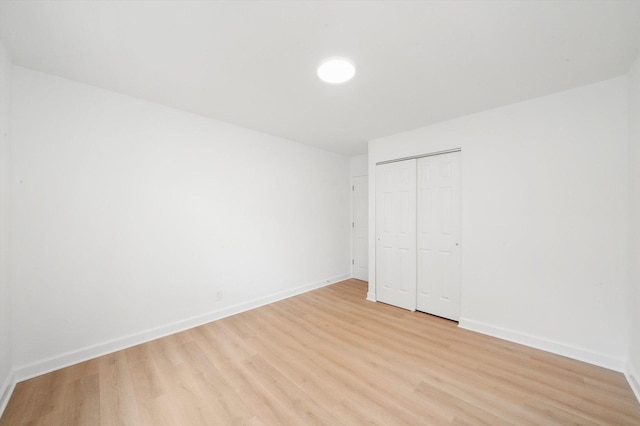 163 Queenswood Rd, Bolingbrook, IL 60440 - unfurnished bedroom with light wood-type flooring, baseboards, and a closet