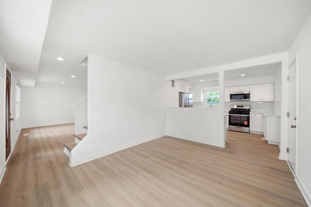 163 Queenswood Rd, Bolingbrook, IL 60440 - unfurnished living room with light wood-style floors, stairway, recessed lighting, and baseboards