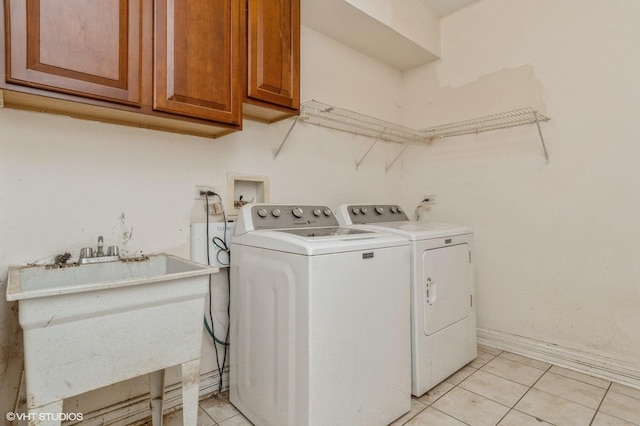 4722 Douglas Rd, Oswego, IL 60543 - laundry room featuring washer and clothes dryer, cabinet space, and light tile patterned floors