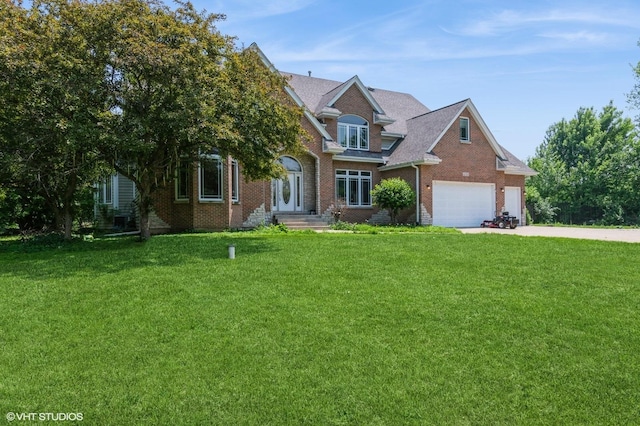 4722 Douglas Rd, Oswego, IL 60543 - traditional-style home with brick siding, driveway, a front lawn, and a garage