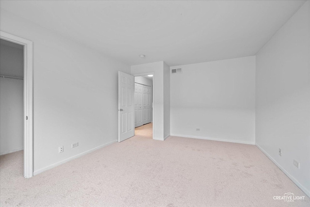 1096 Village Center Pkwy Unit 6, Aurora, IL 60506 - unfurnished bedroom featuring a spacious closet, carpet floors, baseboards, and a closet