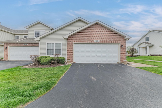 303 Capitol Dr Unit A, Sugar Grove, IL 60554 - traditional home with driveway, brick siding, a front lawn, and an attached garage