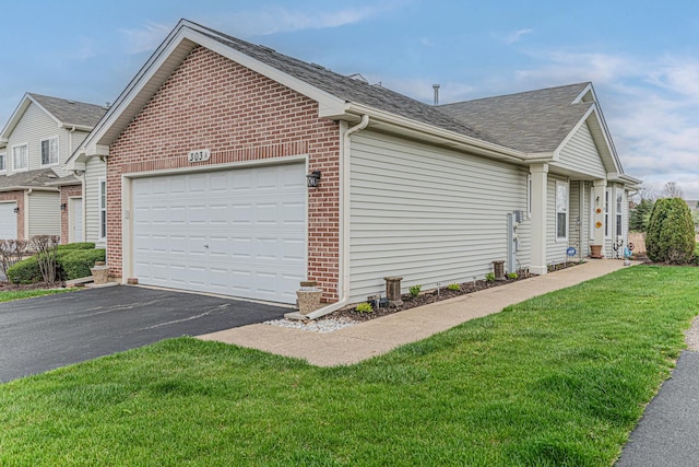 303 Capitol Dr Unit A, Sugar Grove, IL 60554 - view of property exterior featuring an attached garage, brick siding, driveway, roof with shingles, and a yard