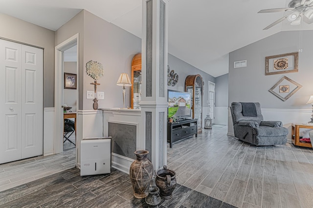 303 Capitol Dr Unit A, Sugar Grove, IL 60554 - living area featuring wood finish floors, ceiling fan, vaulted ceiling, and arched walkways