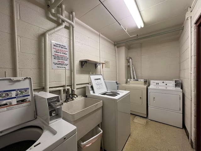603 S River Rd Unit 2K, Des Plaines, IL 60016 - communal laundry room with washer and dryer, concrete block wall, and light floors