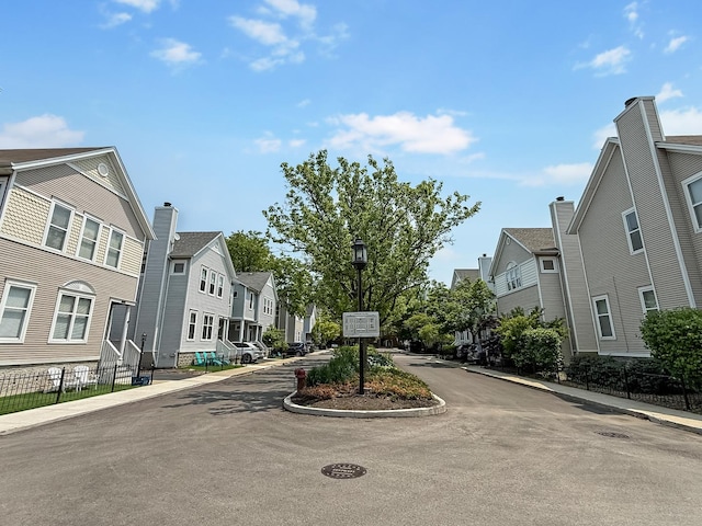 2847 N Wolcott Ave Unit D, Chicago, IL 60657 - view of asphalt road featuring a residential view, sidewalks, street lighting, and curbs