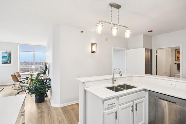 1111 S Wabash Ave Unit 1410, Chicago, IL 60605 - kitchen featuring a sink, dishwasher, light wood-type flooring, baseboards, and light countertops
