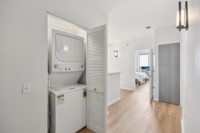 1111 S Wabash Ave Unit 1410, Chicago, IL 60605 - laundry area with stacked washer / drying machine, light wood finished floors, and baseboards