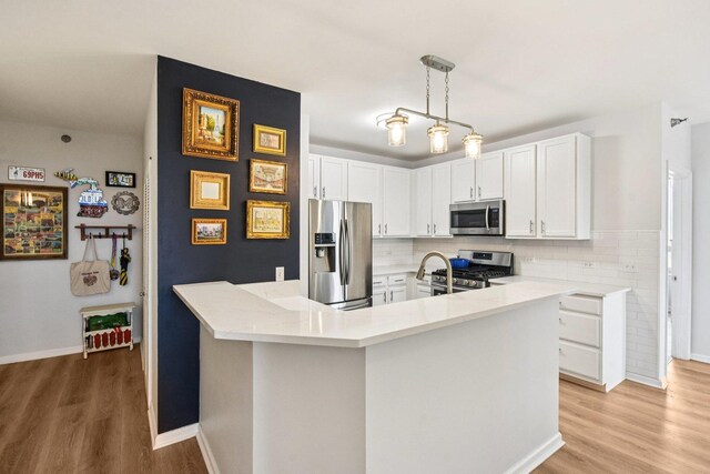 1111 S Wabash Ave Unit 1410, Chicago, IL 60605 - kitchen with appliances with stainless steel finishes, light wood-style flooring, light countertops, white cabinets, and decorative backsplash