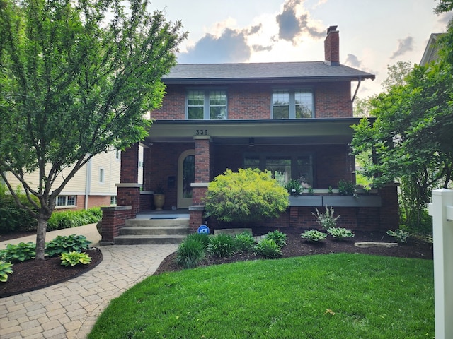 336 S Sleight St, Naperville, IL 60540 - view of front of house with covered porch, brick siding, a front yard, and a chimney