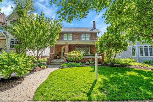 336 S Sleight St, Naperville, IL 60540 - view of front of house featuring brick siding, a front yard, a chimney, and covered porch