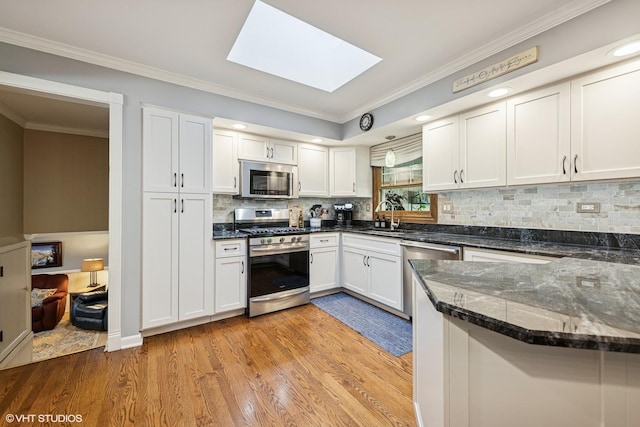 3S180 Cypress Dr, Glen Ellyn, IL 60137 - kitchen with appliances with stainless steel finishes, a sink, ornamental molding, light wood-type flooring, and a skylight
