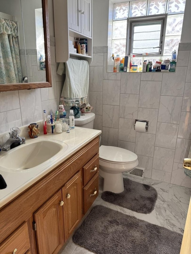 7711 Massasoit Ave, Burbank, IL 60459 - bathroom featuring tile walls, toilet, vanity, and marble finish flooring