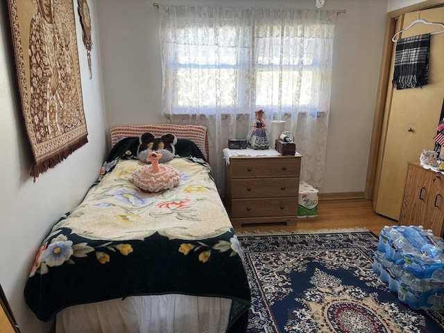 7711 Massasoit Ave, Burbank, IL 60459 - bedroom featuring multiple windows and wood finished floors