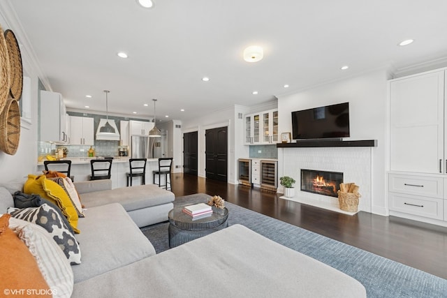 1959 W Berwyn Ave, Chicago, IL 60640 - living area featuring ornamental molding, wine cooler, dark wood-style floors, recessed lighting, and a glass covered fireplace