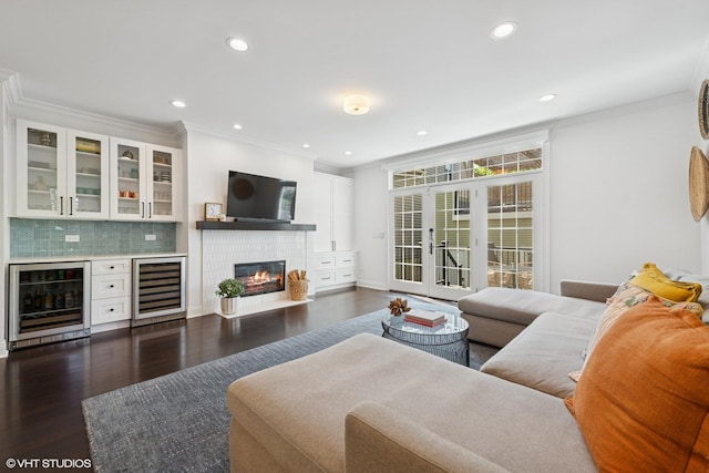 1959 W Berwyn Ave, Chicago, IL 60640 - living area featuring wine cooler, ornamental molding, dark wood finished floors, recessed lighting, and a fireplace with flush hearth