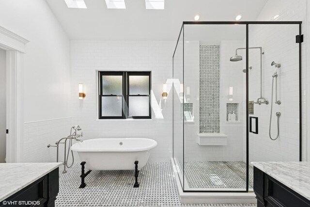 1959 W Berwyn Ave, Chicago, IL 60640 - bathroom featuring vanity, a freestanding bath, a stall shower, tile walls, and a skylight