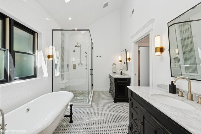 1959 W Berwyn Ave, Chicago, IL 60640 - bathroom featuring a shower stall, two vanities, a freestanding tub, and high vaulted ceiling