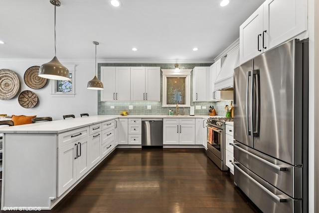 1959 W Berwyn Ave, Chicago, IL 60640 - kitchen featuring stainless steel appliances, a peninsula, backsplash, white cabinetry, and decorative light fixtures